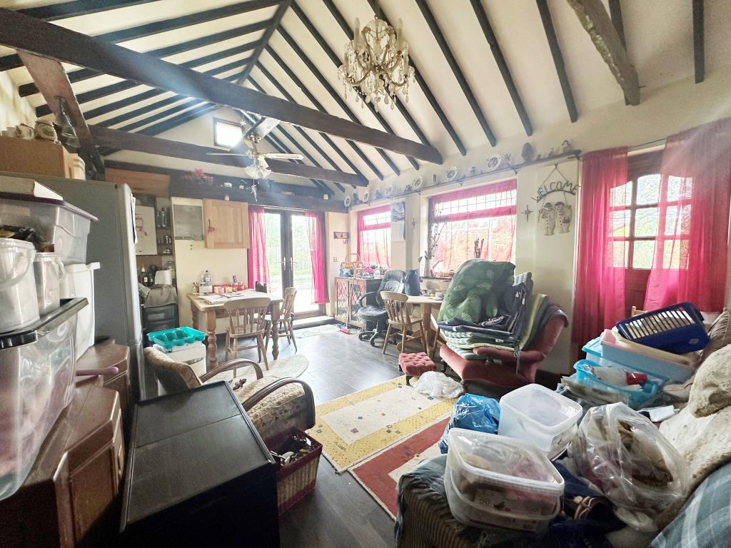 Lot: 84 - LAND WITH BUILDING, CARAVAN AND SWIMMING POOL IN RURAL LOCATION - Living room with vaulted ceilings and kitchen